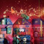Tres cajas del Calendario de Adviento Sabon 2024 sobre un fondo rojo festivo
