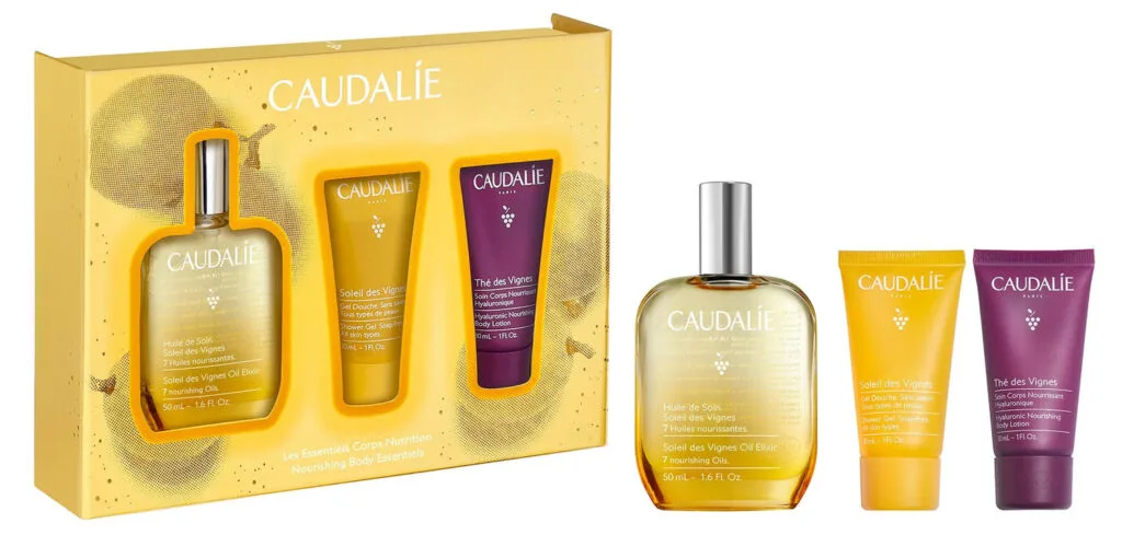 La caja amarilla y los tres productos del set Caudalie Christmas 2024 The Soleil Nourishing Body Essentials